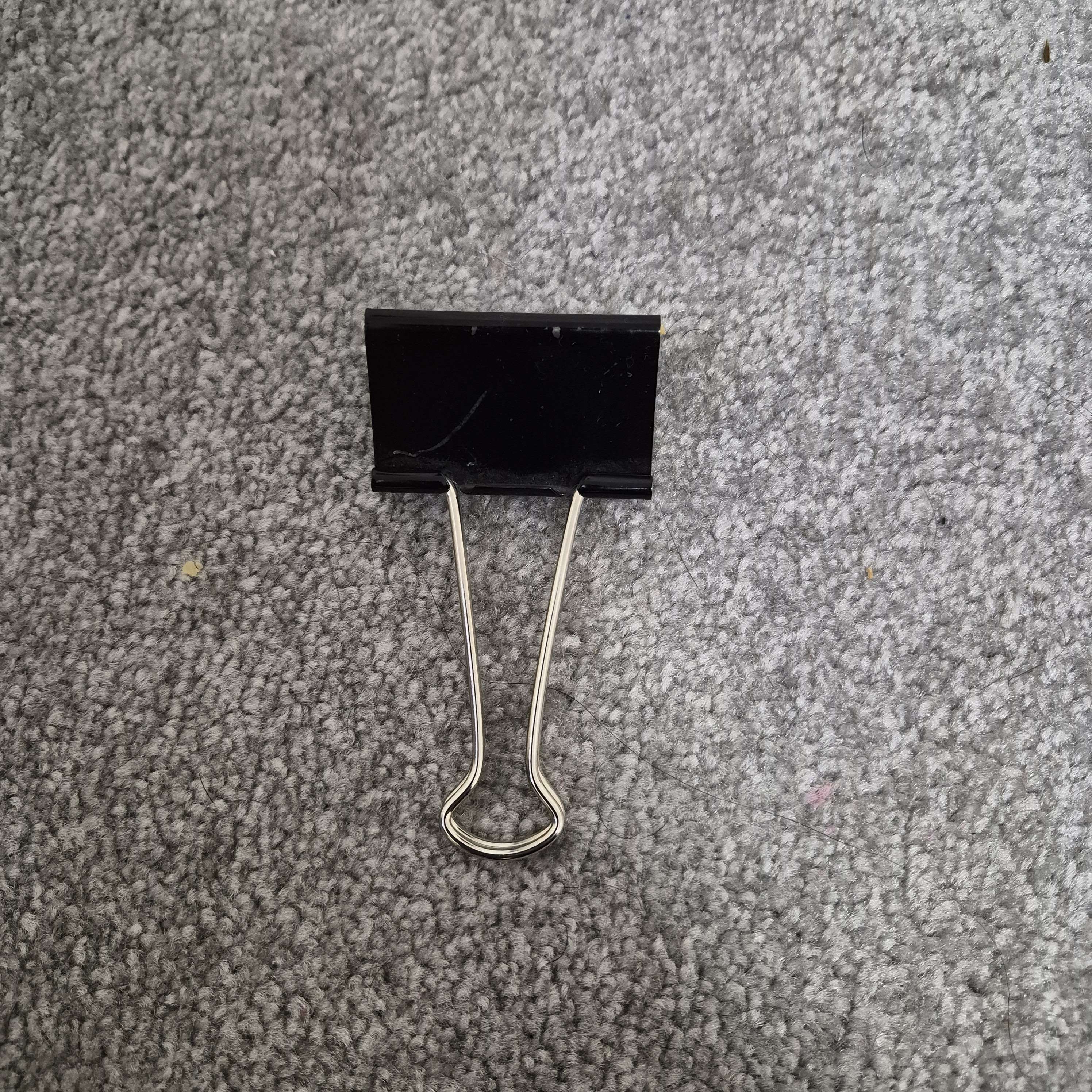 A metal binder clip is used as a conductive input, allowing touch interaction through the Makey Makey.