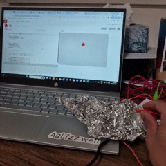 Tapping the tin foil connected to the LEFT - on the Makey Makey forces the bouncing red ball to move toward the left side of the screen regardless of its position.